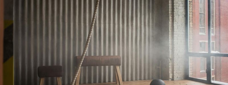 Wide view of a minimalist industrial style workout space.